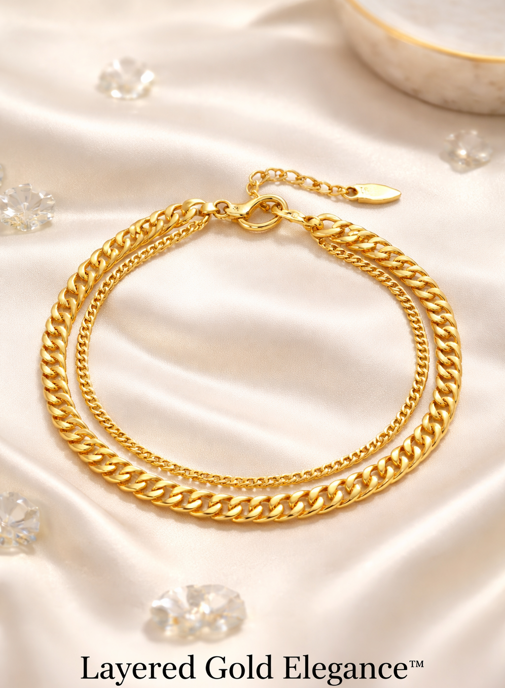 Gold chain bracelet on a soft fabric background with 'Layered Gold Elegance' text.